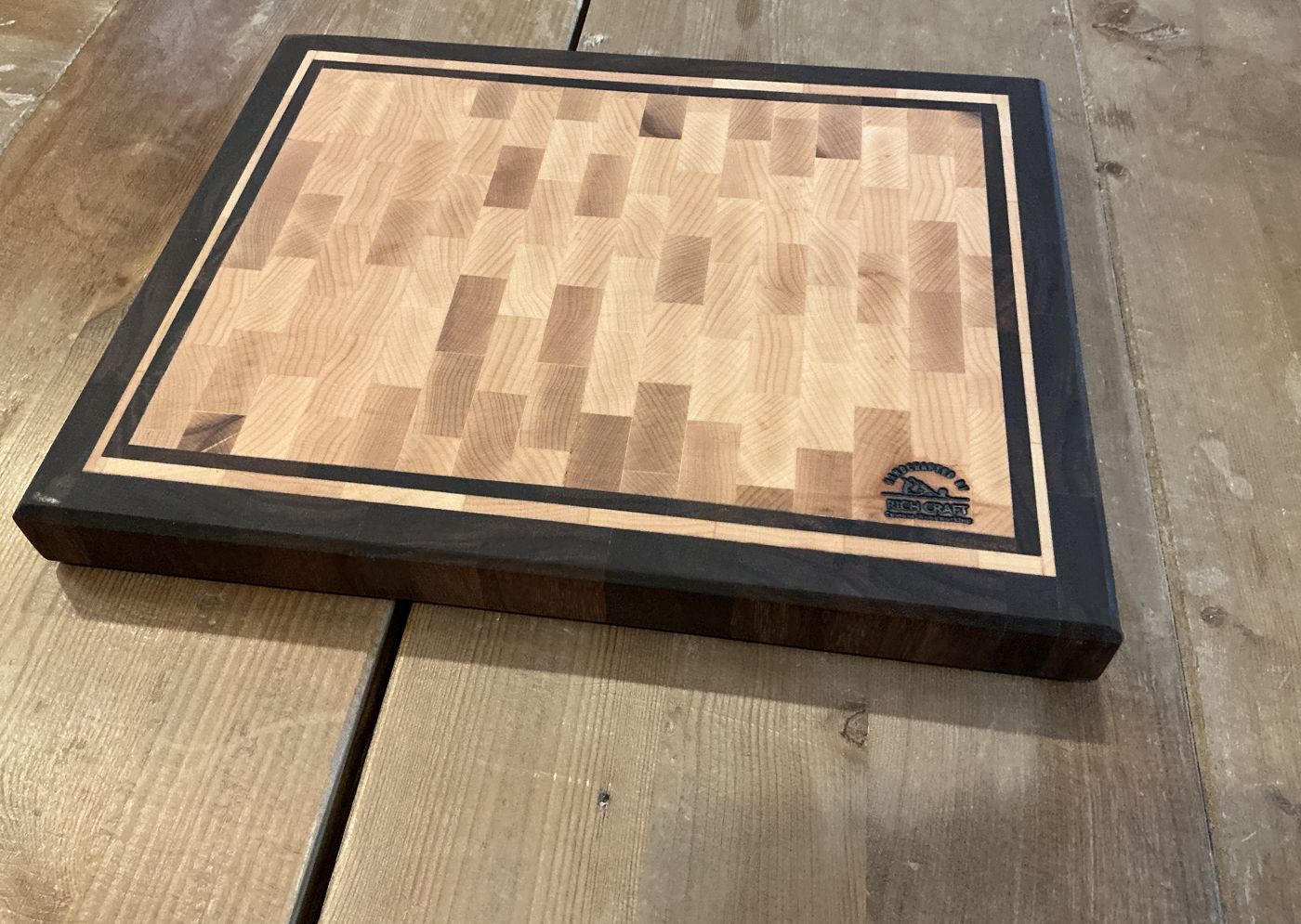 End-grain maple cutting board framed in walnut