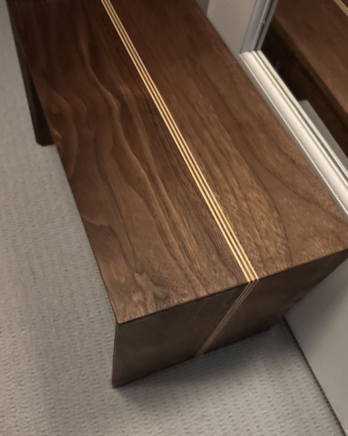 Walnut waterfall bench with a maple inlay stripe
